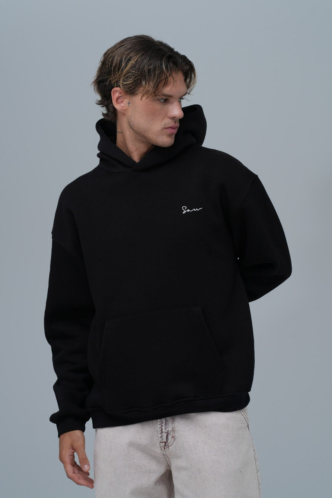 Model wearing the Framed Elegance Hoodie in Black by KOVA Amsterdam